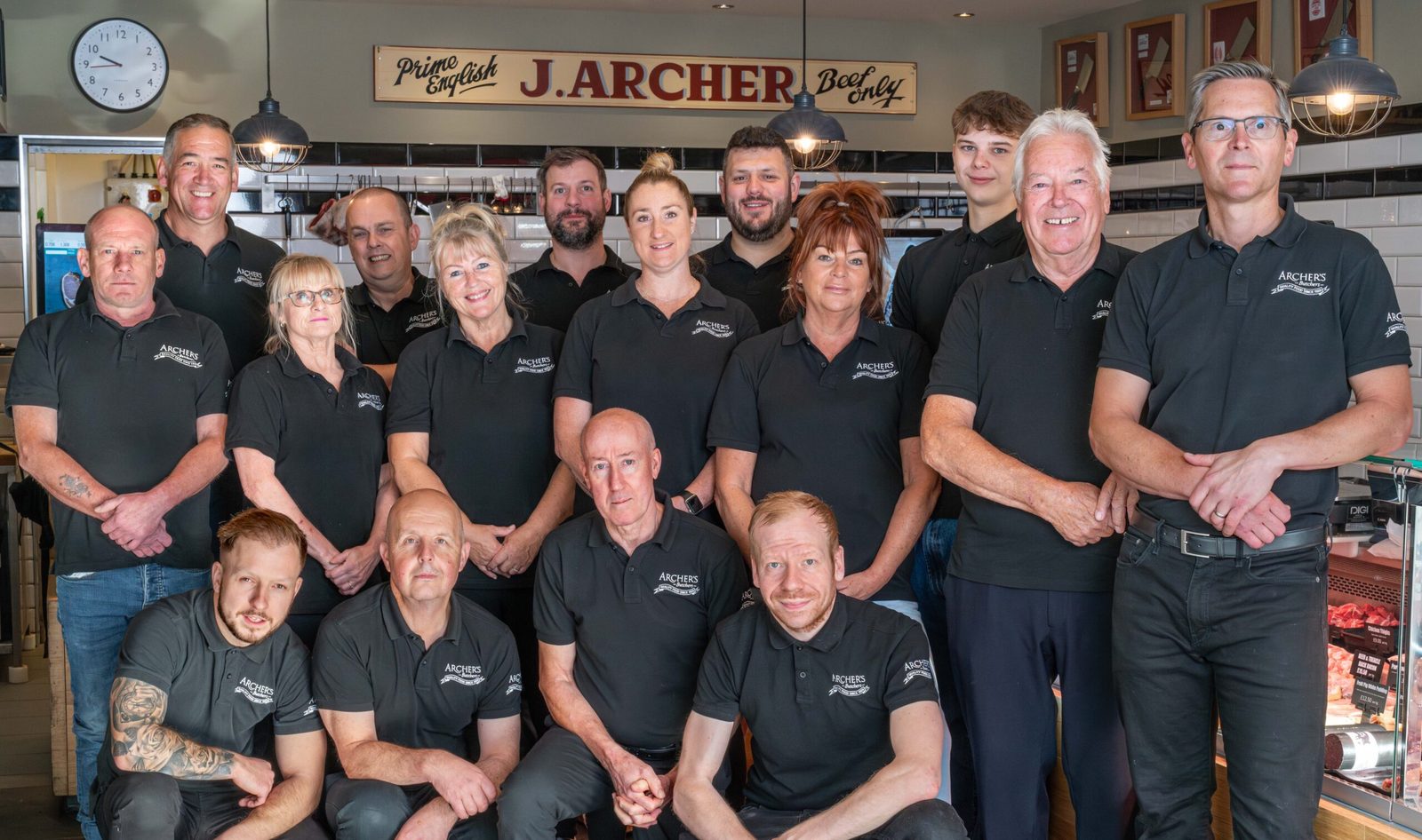 The Archer's Butchers team in white aprons behind the Plumstead Road counter, photographed for the shop in November 2022